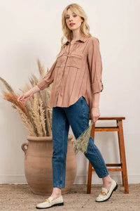 Woman in a dusty pink striped button shirt with blue jeans, showcasing the Multi Striped Button style