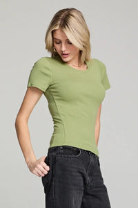 Woman in fitted green crew neck tee and black jeans from Shop Daisy’s women’s boho chic clothing