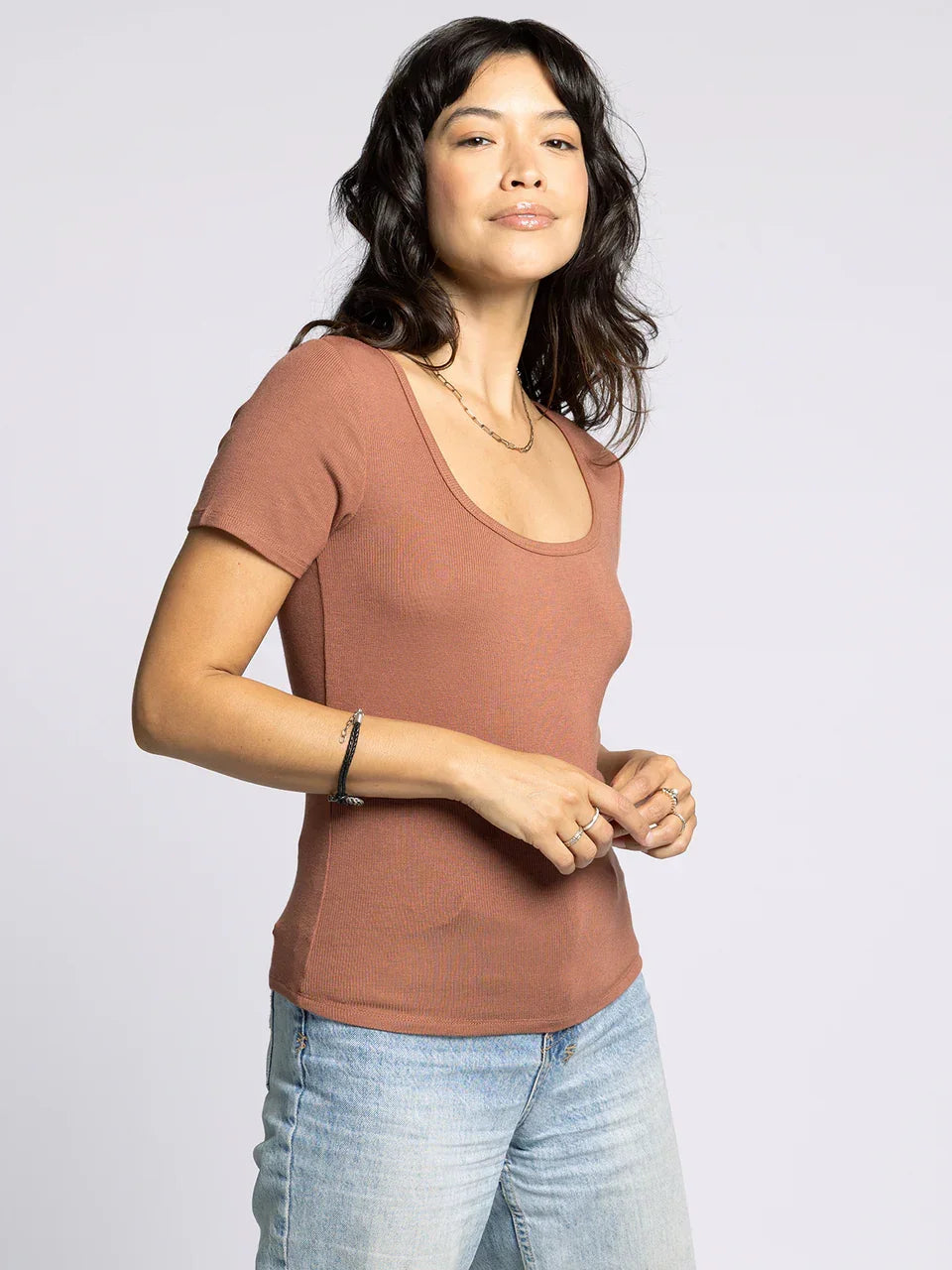 Woman wearing a supply katara tee and light-wash jeans showcasing the Katara Tee