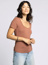 Woman wearing a supply katara tee and light-wash jeans showcasing the Katara Tee