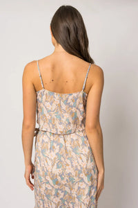 Woman in a sleeveless floral tank dress with a vibrant floral pattern, viewed from behind