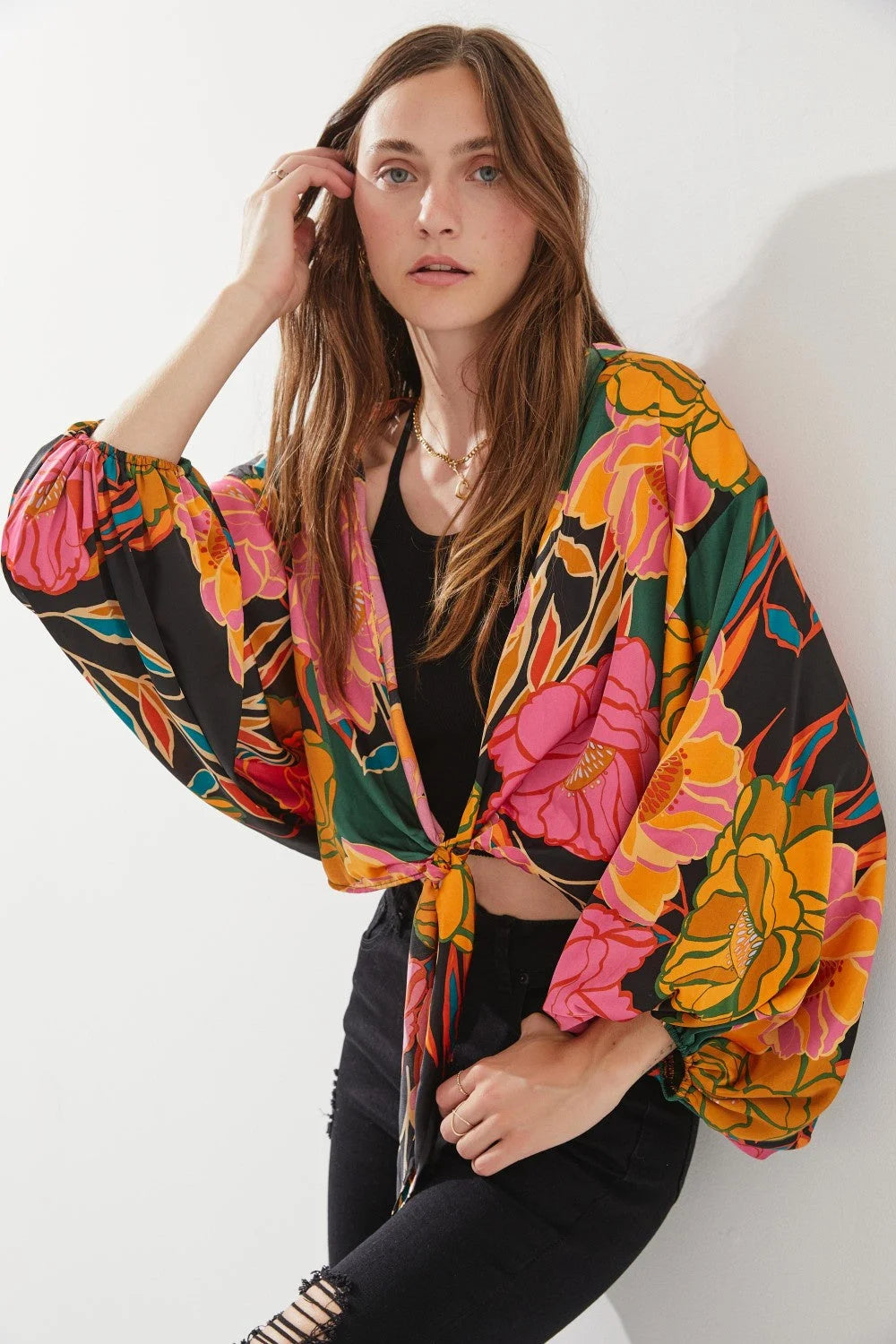 Woman showcasing a Floral Print Tie-Front Cardigan with vibrant floral design