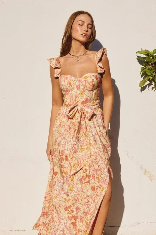 Woman in a floral print SUNNY DAYS Corset Top Maxi Dress for summer occasions