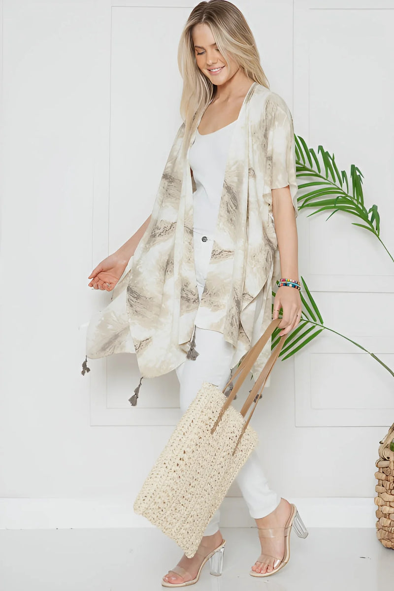 Woman in Mellow Melanie Marble Print Kimono over white outfit, showcasing boho style