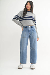 Woman in a gray striped sweater showcasing Utility Seamed Barrel Jean with wide-leg fit
