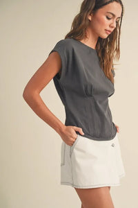 Woman in a gray t-shirt and white shorts showcasing a Corset Style Body Top