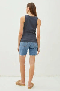 Woman in gray tank top and denim shorts featuring raised hem from Shop Daisy