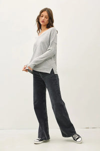 Woman wearing ultra soft long sleeve V-neck sweater in women’s boho chic clothing from Shop Daisy
