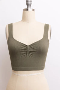 Woman modeling a Basic Ribbed Cinched Crop Top in vibrant green color