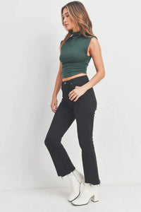 Woman wearing a green crop top and black jeans featuring Vintage Cropped Flare Denim