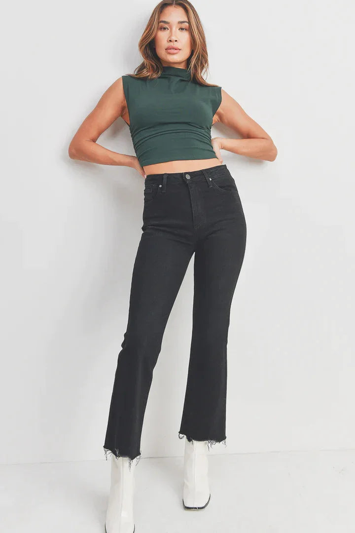 Woman in green crop top and black jeans showcasing Vintage Cropped Flare Denim