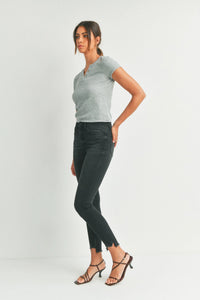 Woman in a grey top and black jeans wearing High Rise Ankle Skinny Denim