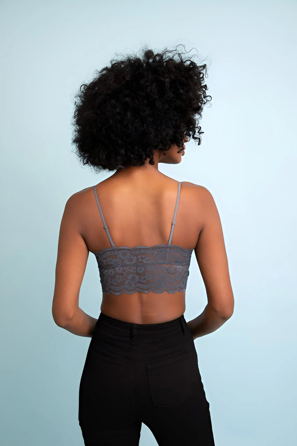 Woman wearing a grey wide lace bandeau with detachable straps for stylish comfort