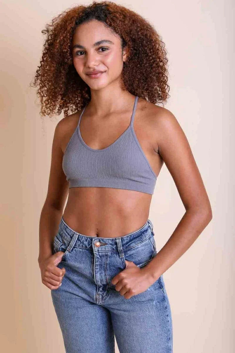 Woman in grey crop top and jeans wearing Tattoo Mesh Racerback Bralette