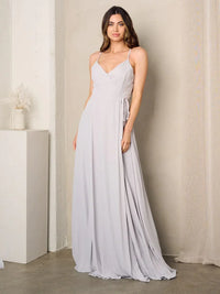 Woman in a grey sleeveless surplice tie maxi dress showcasing elegant style