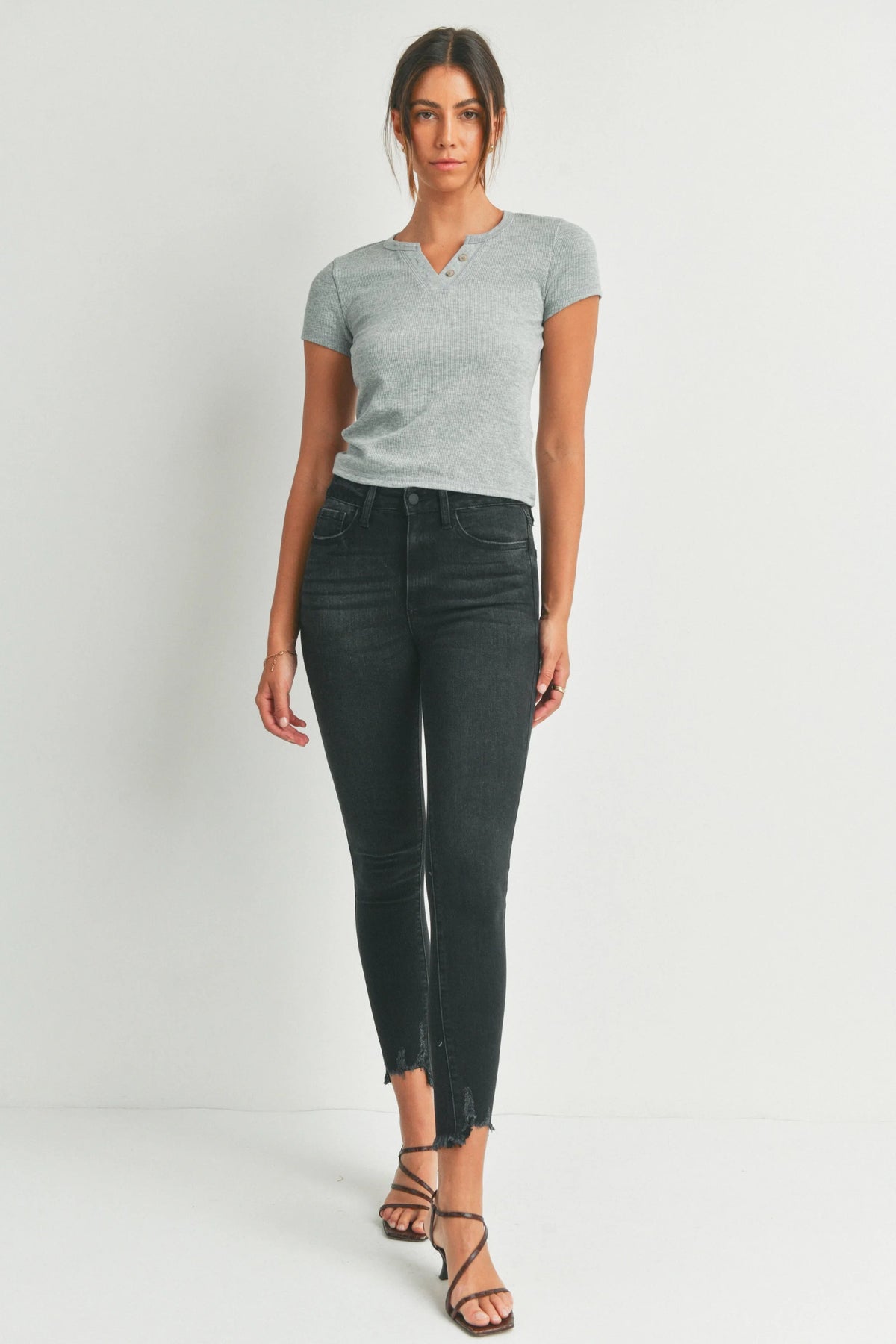 Woman in grey shirt and black jeans wearing High Rise Ankle Skinny Denim