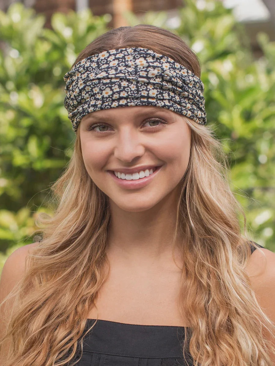 Woman showcasing a boho bandeau headband featuring a black and cream floral pattern