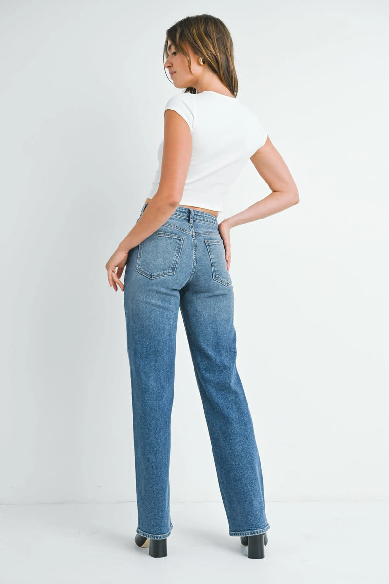 Woman modeling HIGH RISE LONGER LENGTH STRAIGHT TALL DENIM JEANS with white top