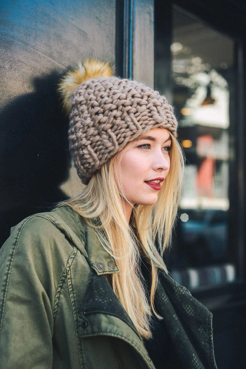 Woman modeling an Oversized Chunky Pom Beanie featuring a stylish knit hat with pom