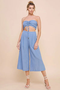 Woman in light blue bamboo textured woven cinch bandeau top with wide-leg culottes