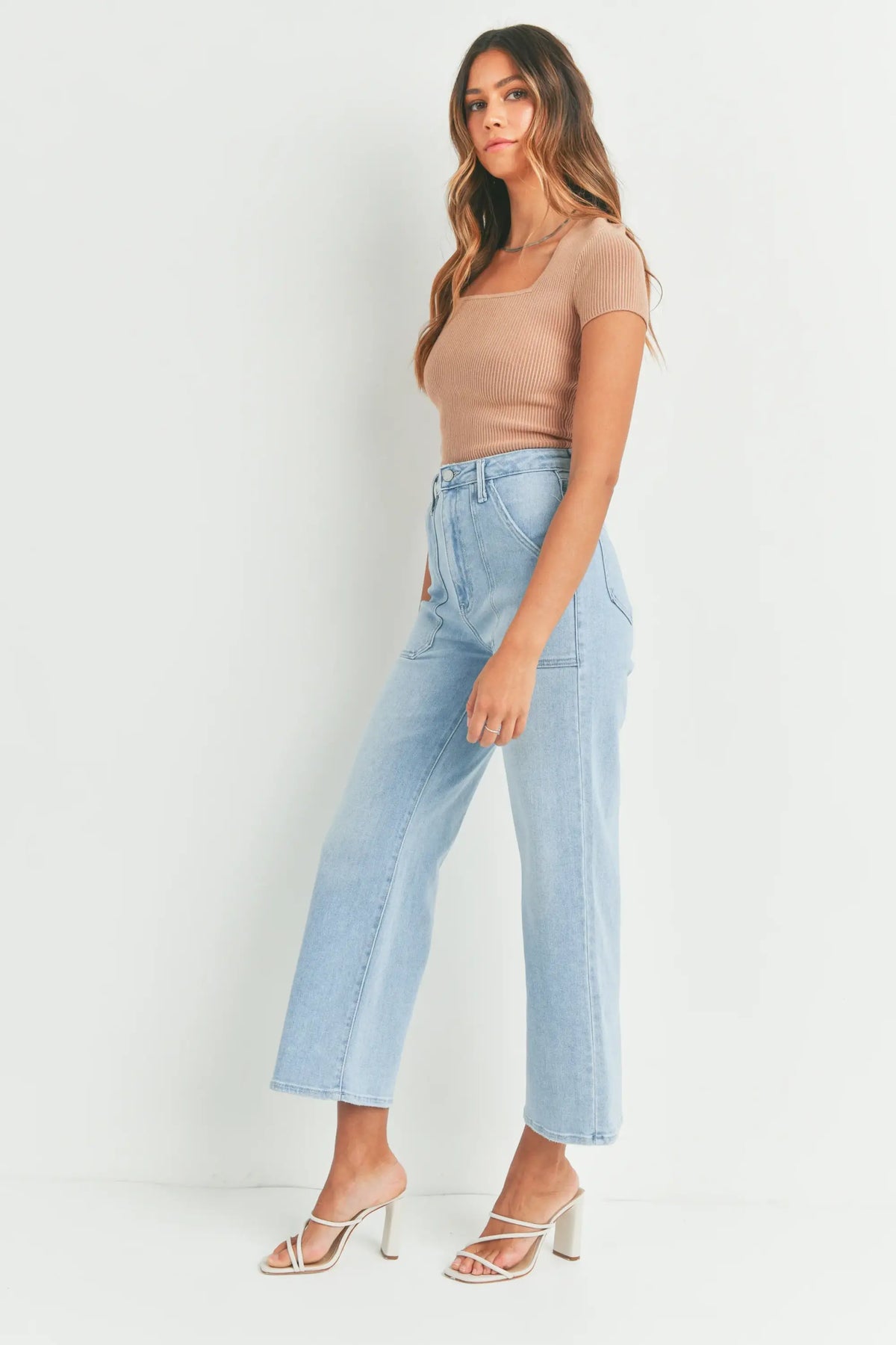 Woman in light blue jeans and tan top showcasing Women’s Boho Chic Clothing by Shop Daisy