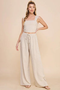 Woman in light-colored two-piece outfit featuring Striped Linen Smock Waist Pants