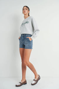 Woman in light gray sweatshirt and denim shorts showcasing HR UTILITY CARGO SHORT, boho style