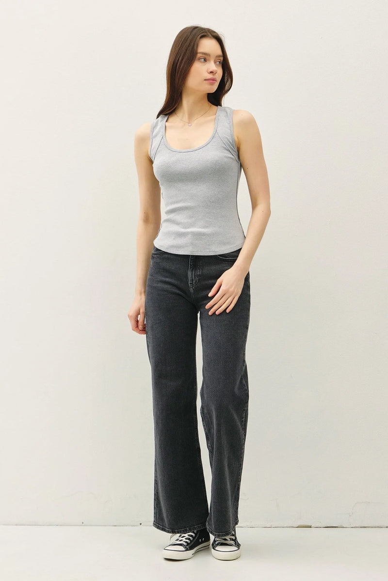 Women’s boho chic clothing featuring a ribbed scoop neck raw seam tank top and dark gray wide-leg jeans