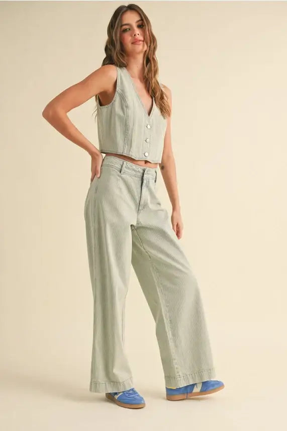 Woman in a light green vest paired with Faded Stripe Pattern Pants for a stylish look