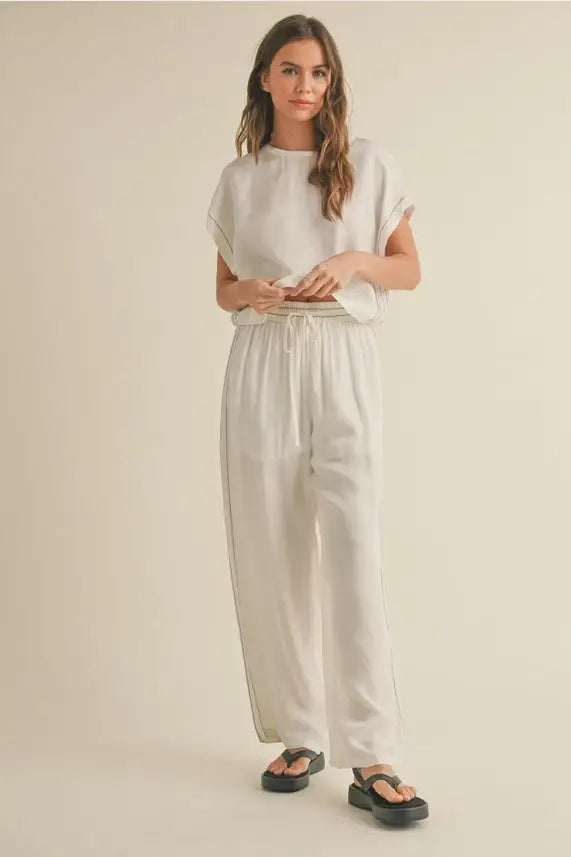 Woman in a linen top and elastic band waist pants set showcasing comfort and style