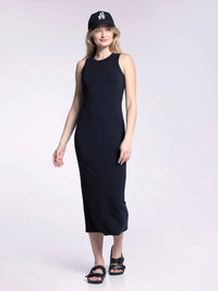 Woman in a long black tank fitted midi dress and baseball cap, showcasing stylish comfort