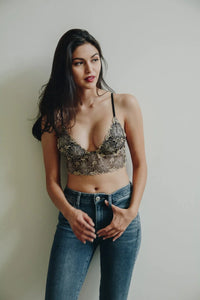 Woman in lace bralette and jeans showcasing women’s boho chic clothing from Shop Daisy