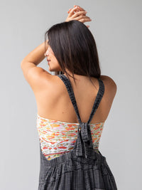 Woman with long dark hair in backless dress showcasing Lilac Orange Border Boho Bandeau® headband