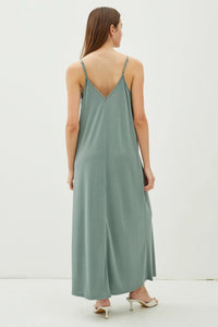 Woman wearing a green adjustable strap maxi dress showcasing V-NECK ADJUSTABLE STRAP MAXI DRESS