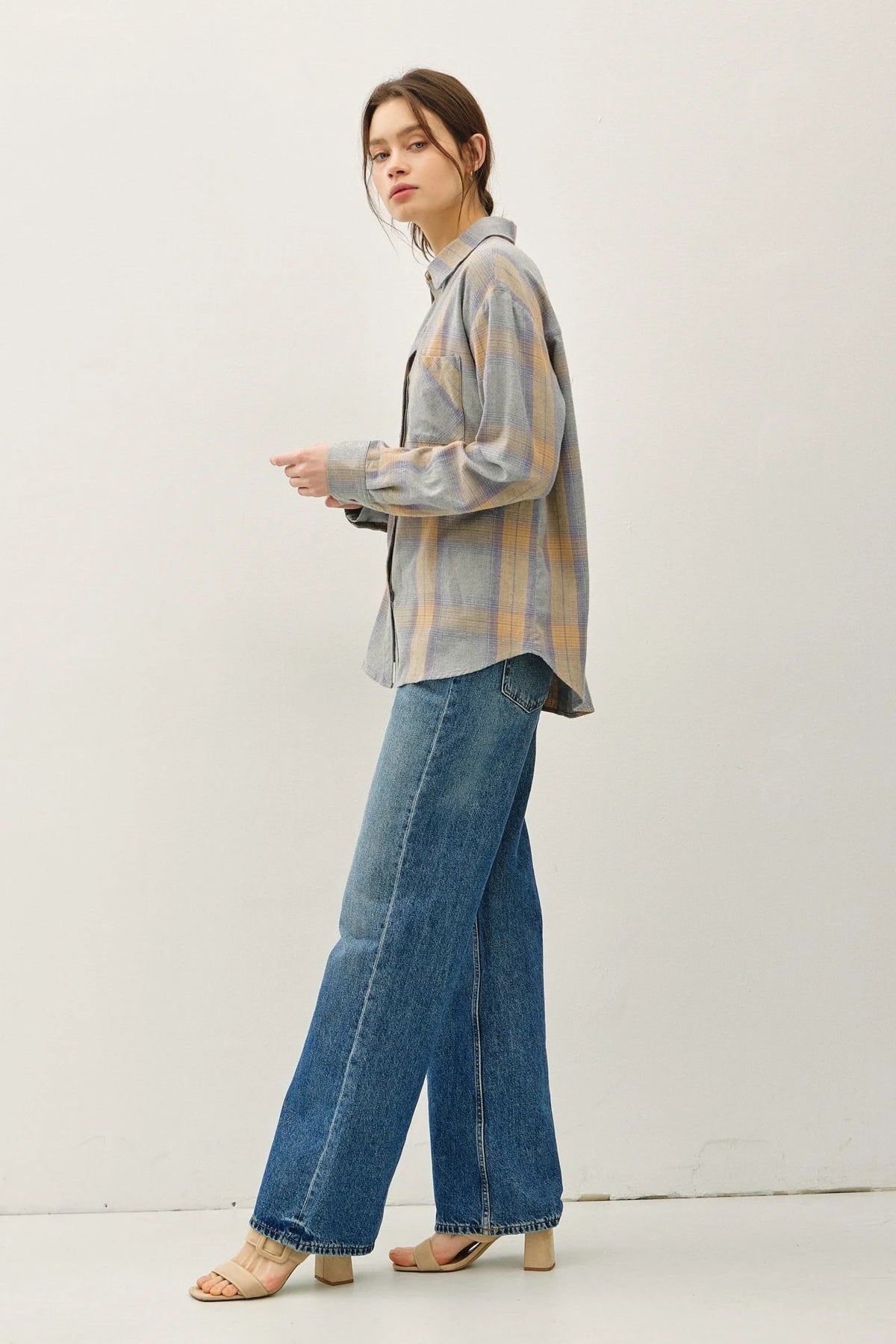 Woman modeling classic cotton faded plaid shirt with wide-leg jeans and open-toed sandals