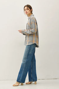Woman modeling classic cotton faded plaid shirt with wide-leg jeans and open-toed sandals