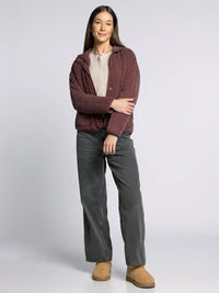 Woman wearing the supply brina jacket in maroon quilted puffer style with hood