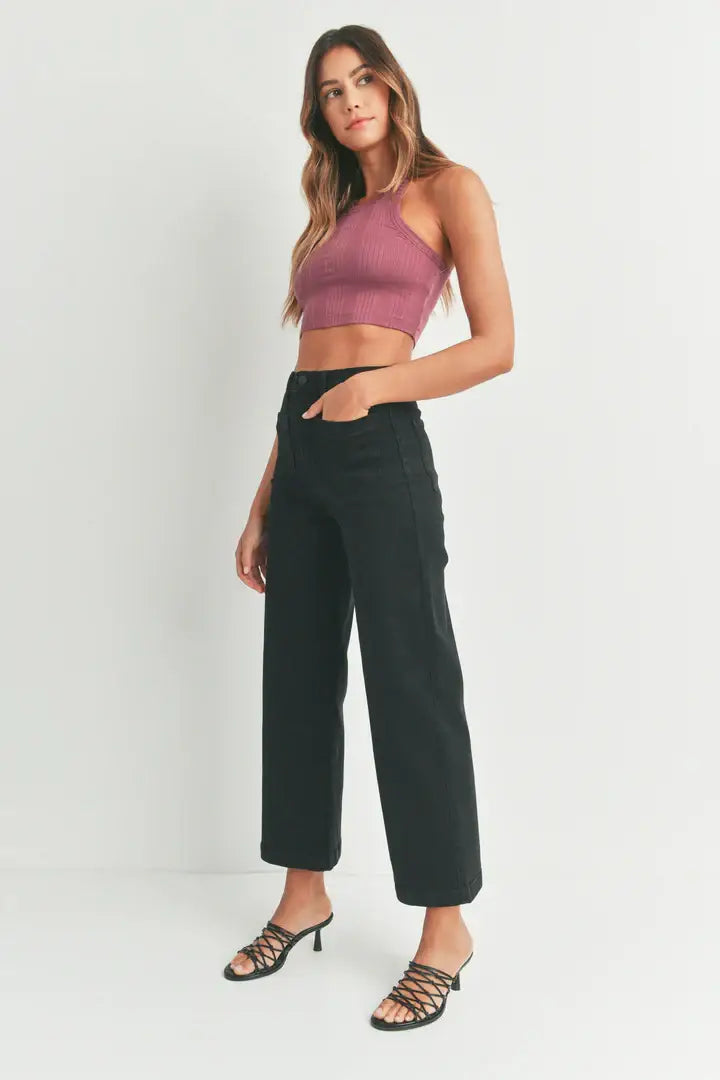 Woman in mauve crop top and black pants showcasing women’s boho chic sailor pocket wide leg jeans
