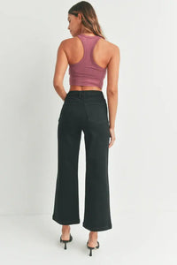 Woman in mauve racerback crop top and black wide leg jeans from women’s boho chic collection