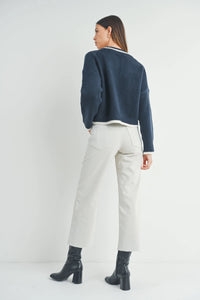 Woman in navy blue cropped sweater and white pants styled with Nautical Wide Leg Denim