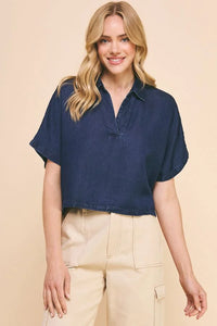 Woman modeling a Washed Chambray Collared Relaxed Crop Top in navy blue