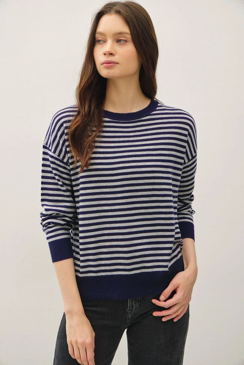 Woman modeling navy blue and white wool blended striped sweater top