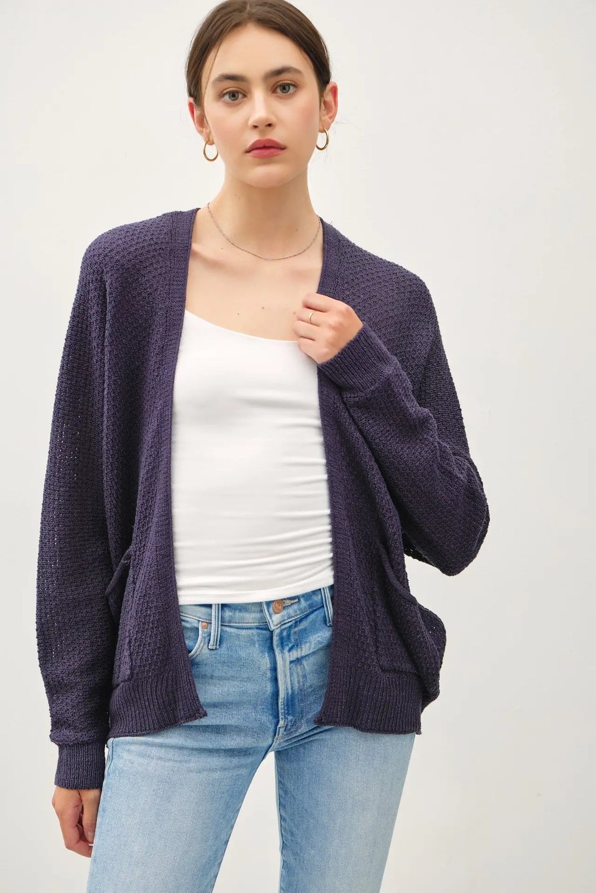 Woman wearing a navy cardigan from Shop Daisy’s womens boho clothes collection