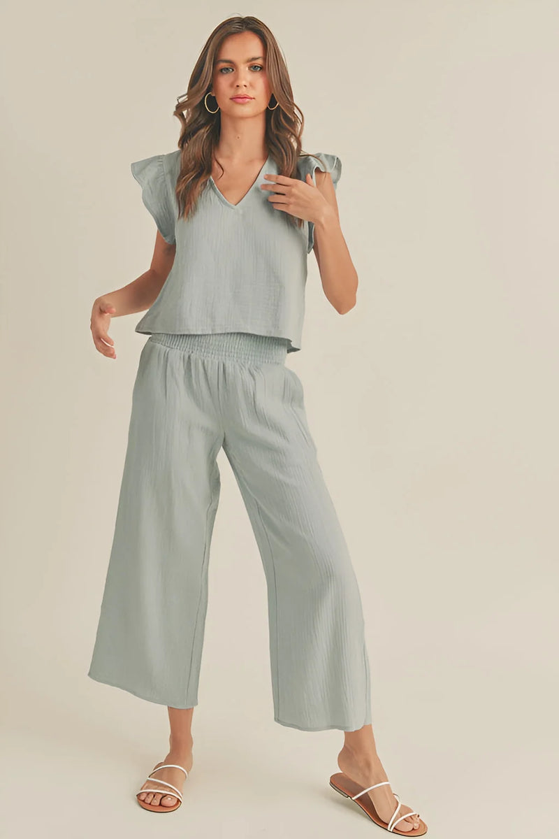 Woman in pale green double gauze smocking waist outfit with wide-leg cropped pants