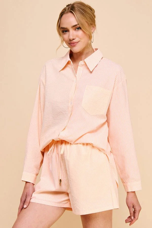 Woman in pale pink stripe cotton blend button-up collar shirt and matching shorts