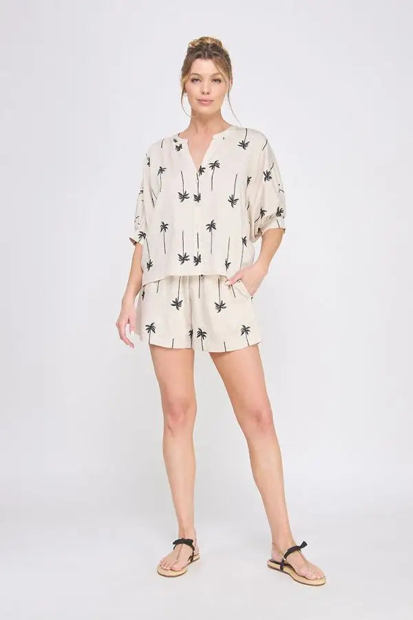 Woman wearing palm tree embroidered lined shorts and matching top for a stylish look