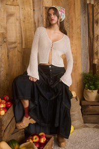 Woman in a peasant-style outfit wearing a BELL SLEEVE CROCHET KNIT CARDIGAN, a stylish knit cardigan