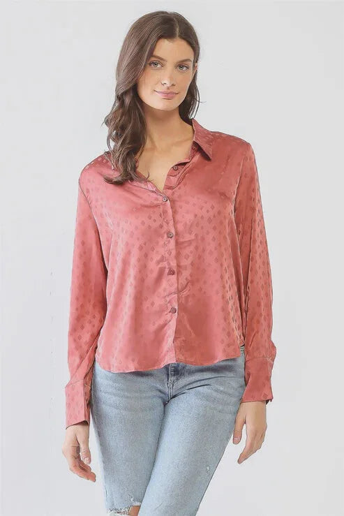 Woman in a pink blouse and jeans showcasing a Satin Diamond Print Button-Up T-Shirt Top