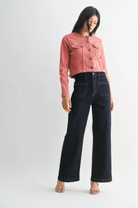 Woman wearing pink cropped denim jacket and wide leg denim jeans with patch pockets