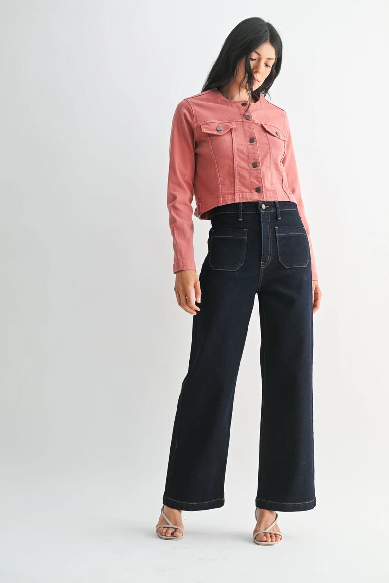 Woman wearing pink cropped denim jacket and wide leg denim jeans with patch pockets